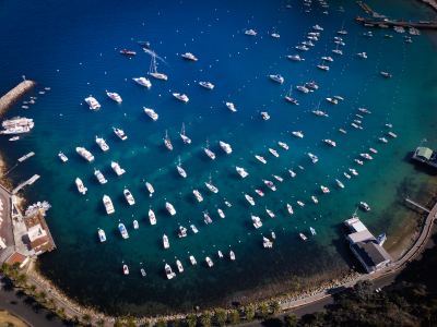 Aerial view of many boats anchored in a sheltered bay