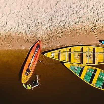 Colourful wooden boats pulled up on a sandy beach