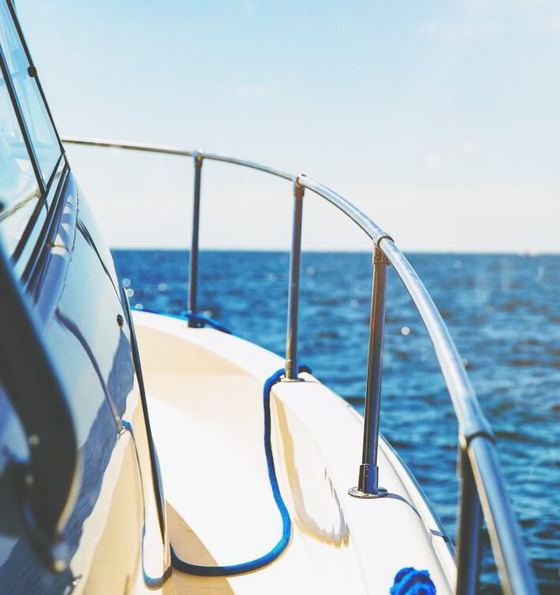View over the bow rail of a yacht heading out to open sea